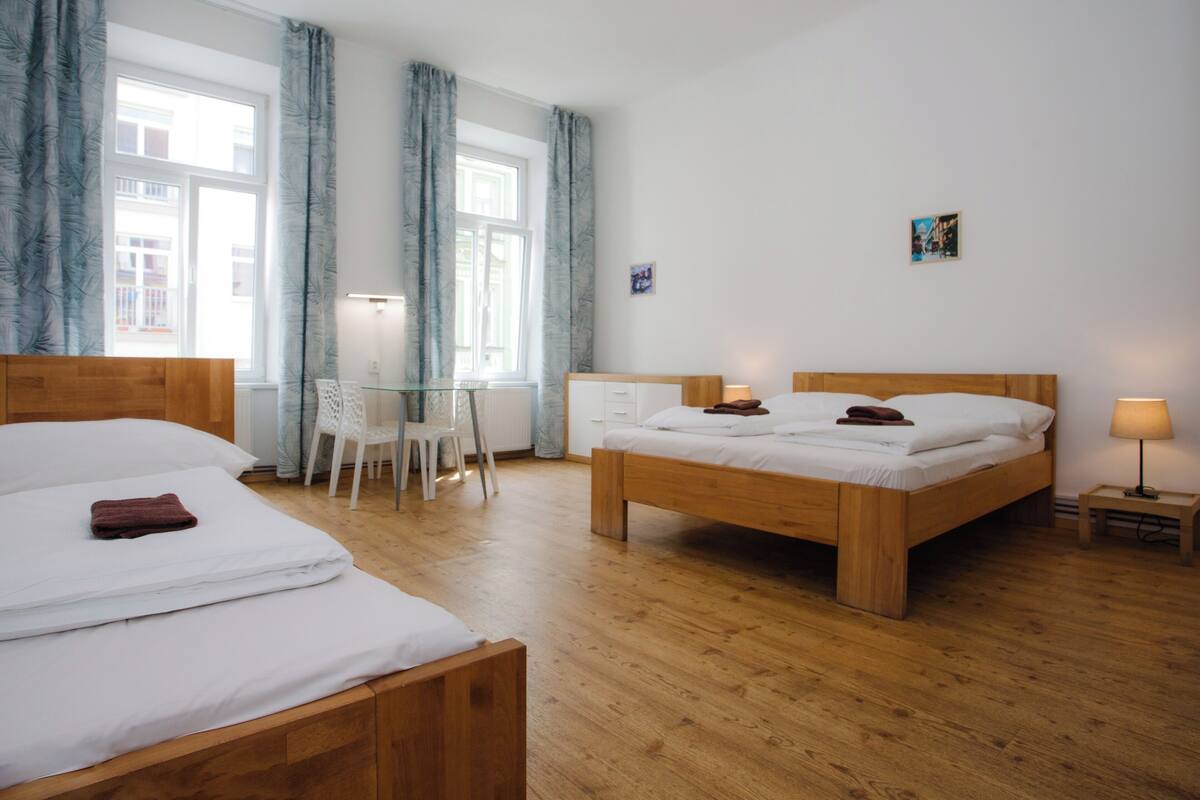 Ein Hotelzimmer mit zwei Betten, einem Schreibtisch und einem Sessel.