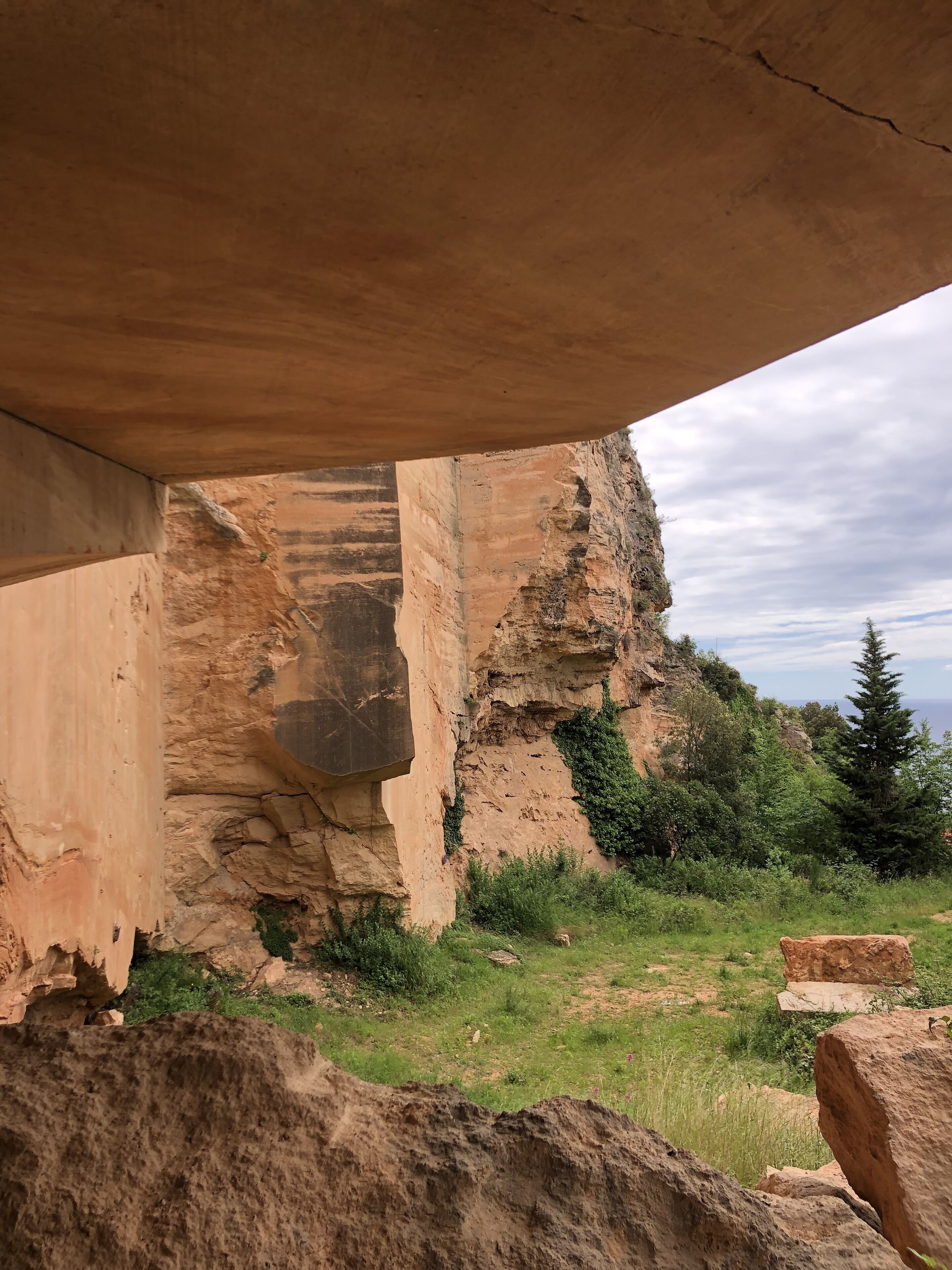 A natural rock formation with a large overhang.