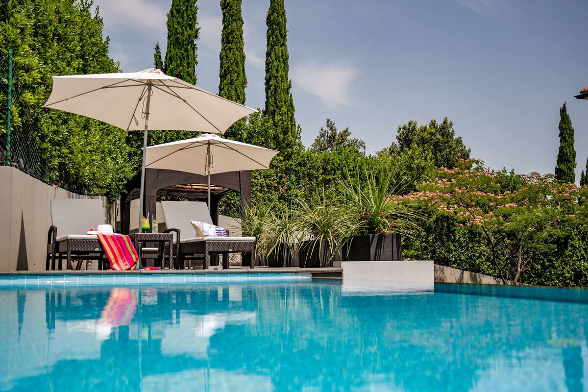 outdoor pool, pool umbrellas, pool loungers