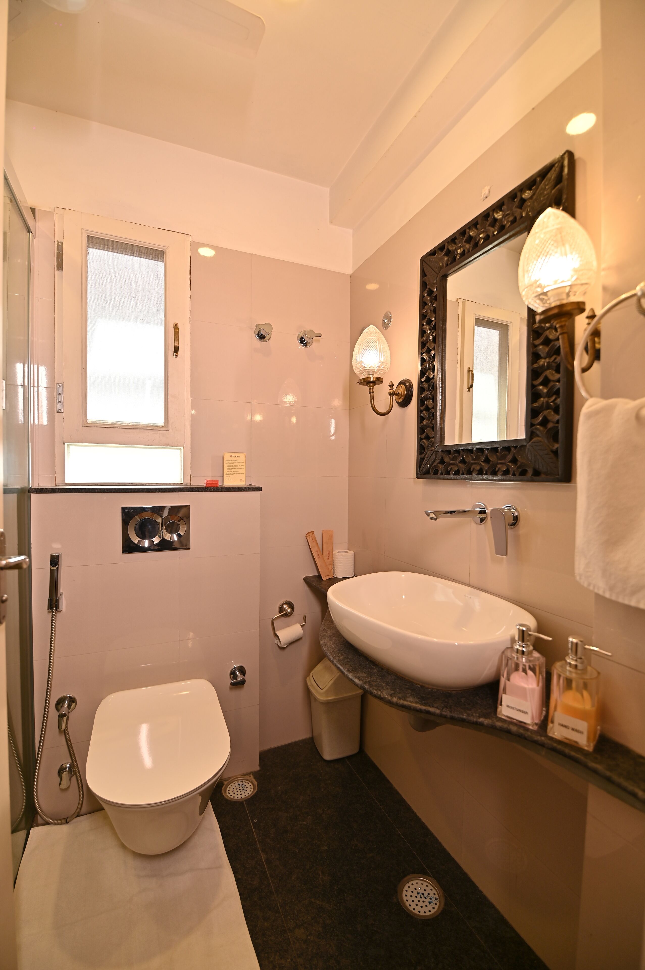 A modern bathroom with a toilet, sink, and shower.