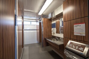 Enjoy a clean and well-maintained restroom with a stainless steel sink and compostable products available.