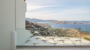 A balcony with a clear view of a coastal landscape, including hills and a body of water. - Adrakos Apartments - Adults Only (Agios Nikolaos)