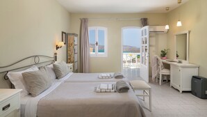 A hotel room with two beds, a balcony with a view, a desk, and a chair. - Adrakos Apartments - Adults Only (Agios Nikolaos)