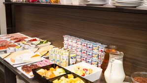 A buffet with various food items and dairy products.
