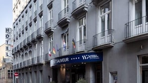 A hotel building with a sign for 'HOTEL SAUVEUR' and 'HOTELS EVENTS' indicating a possible event space.