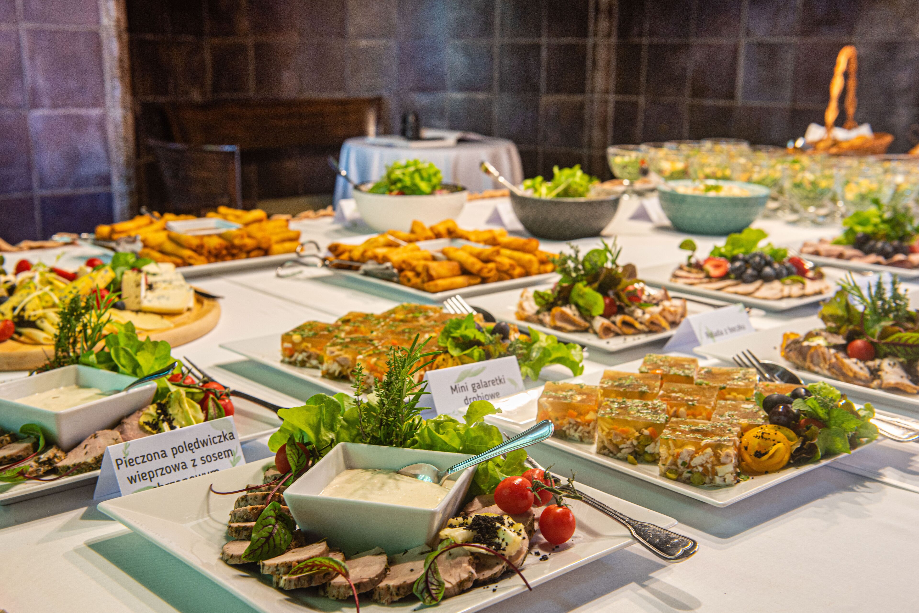 A buffet table with various dishes and salads.
