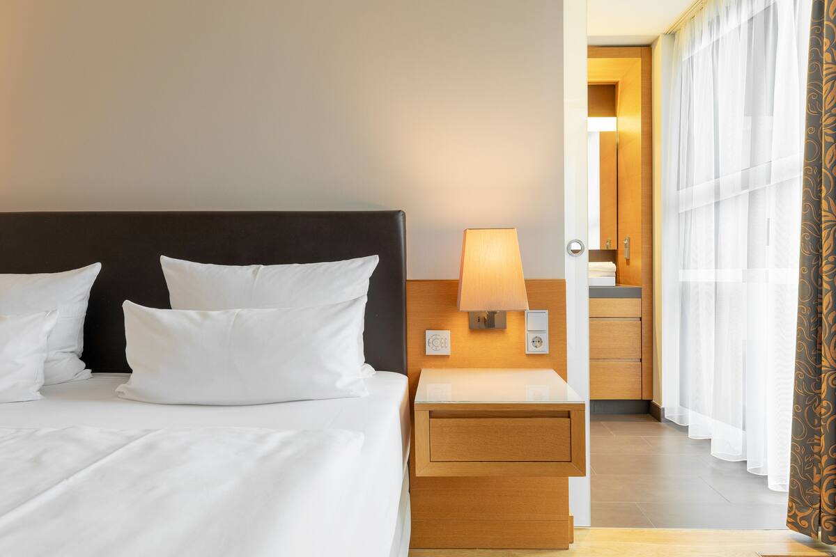 junior suite | in-room safe, individually furnished, desk, iron/ironing board