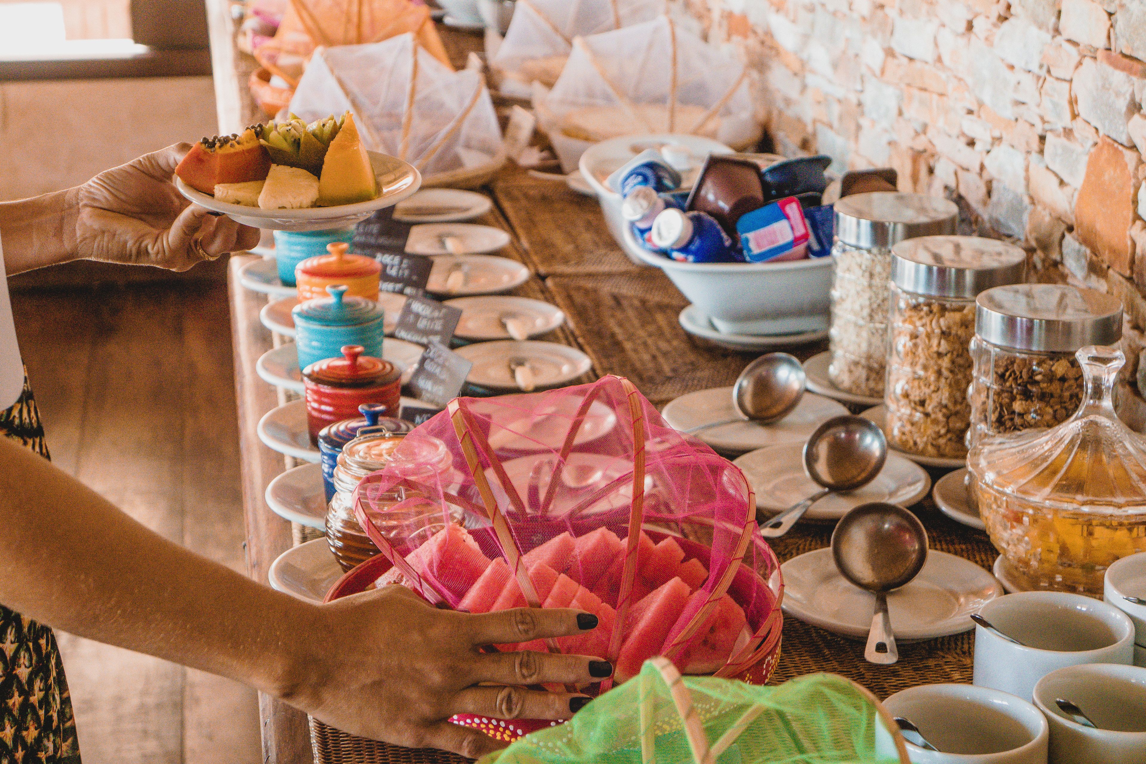 A buffet table with various food items and utensils.