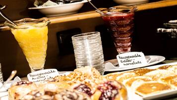 A breakfast buffet with various pastries and drinks.