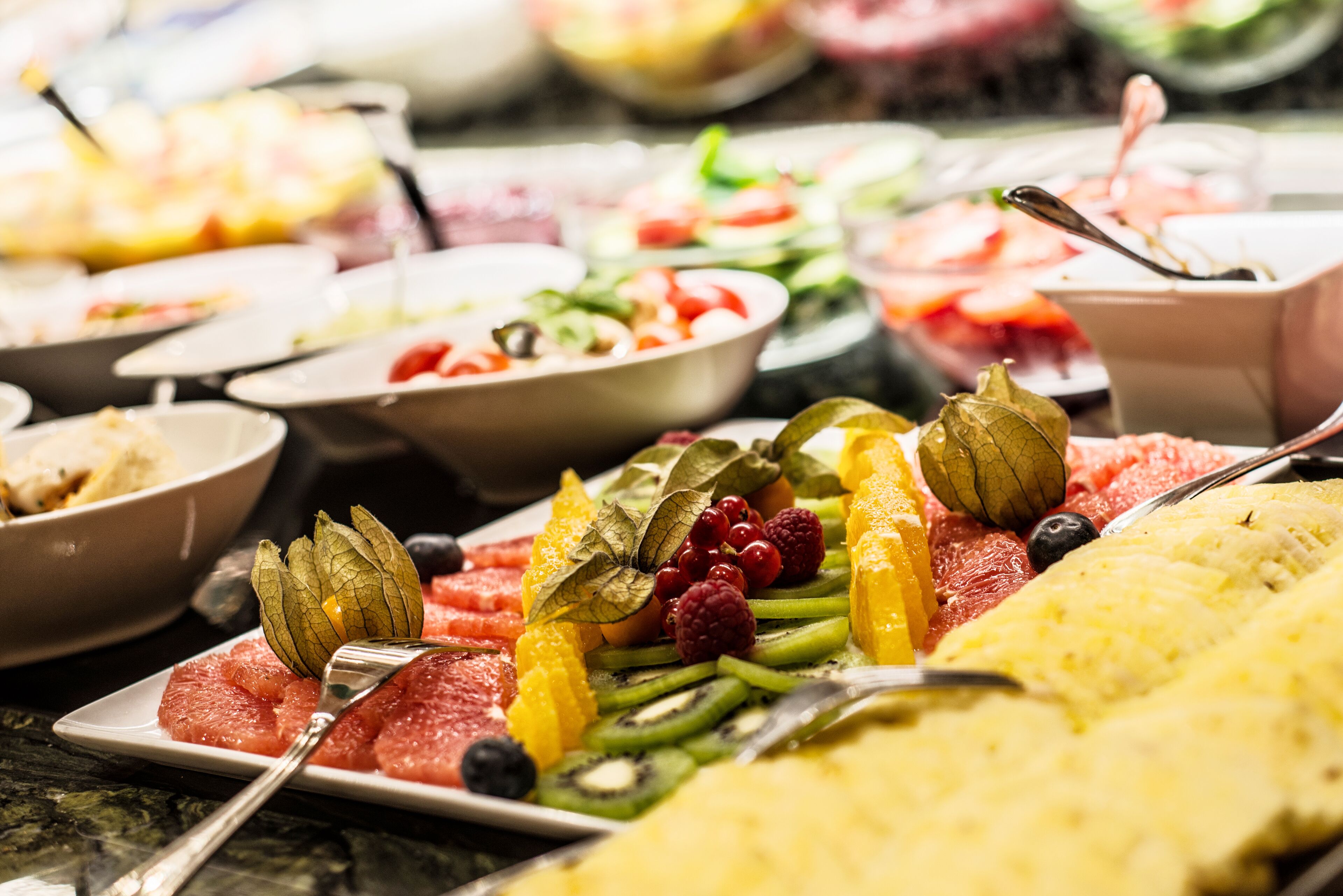 A buffet with various fruits and vegetables.