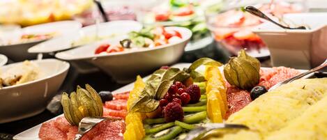 A buffet with various fruits and vegetables.
