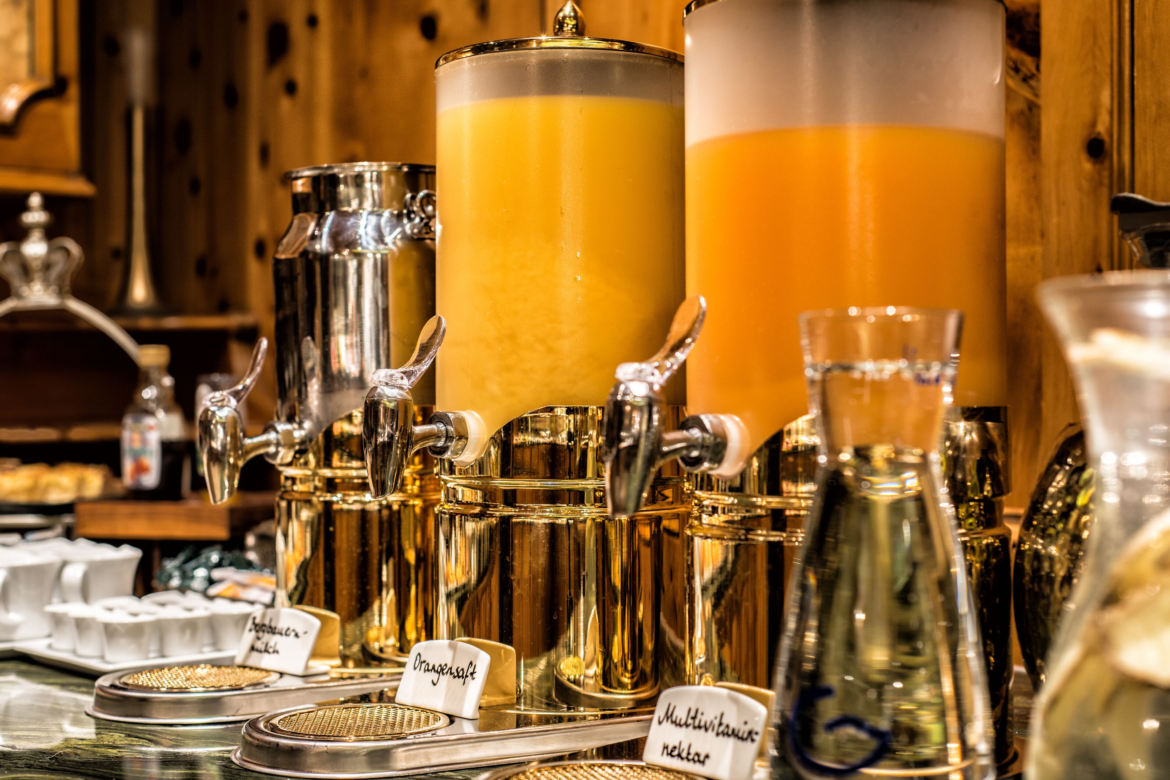 A coffee machine with multiple brewing options, including an orange soft drink and a multivitamin milk option.
