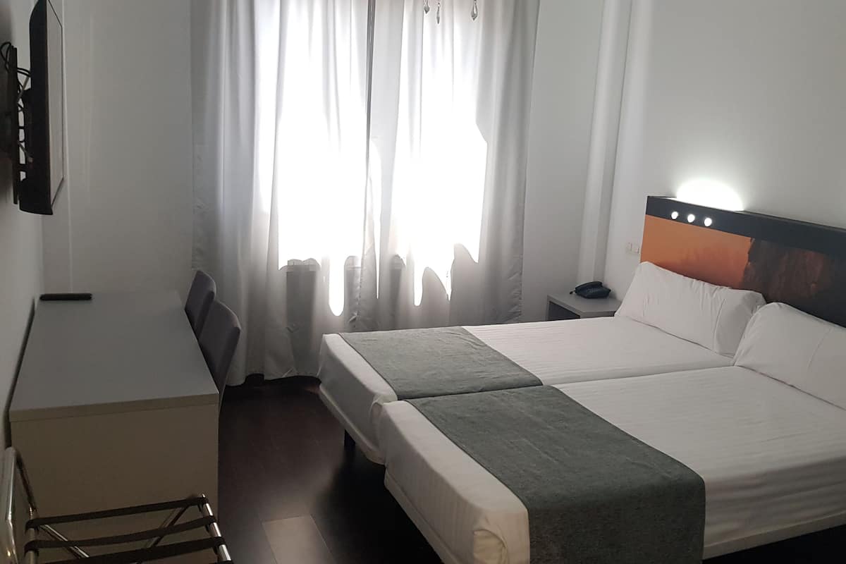Economy Double Room, Ground Floor | Down duvets, minibar, individually furnished, desk