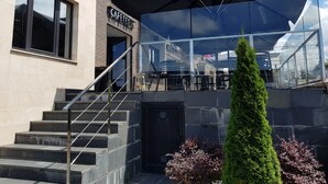 A modern building with a cafe named "CAFFETTER" on the ground floor. - Calas de Liencres (Pielagos)