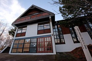 A multi-story building with large windows and a prominent entrance.