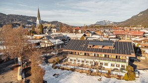 Une ville qui se distingue par une église imposante, des immeubles d’habitation et un grand bâtiment doté de panneaux solaires.
