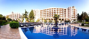 A large hotel with a central swimming pool, multiple balconies, and lush landscaping. - Primoretz Grand Hotel & SPA (Burgas)