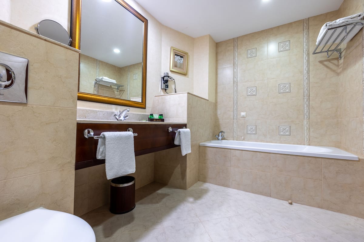 separate bathtub and shower, hair dryer, bathrobes, slippers