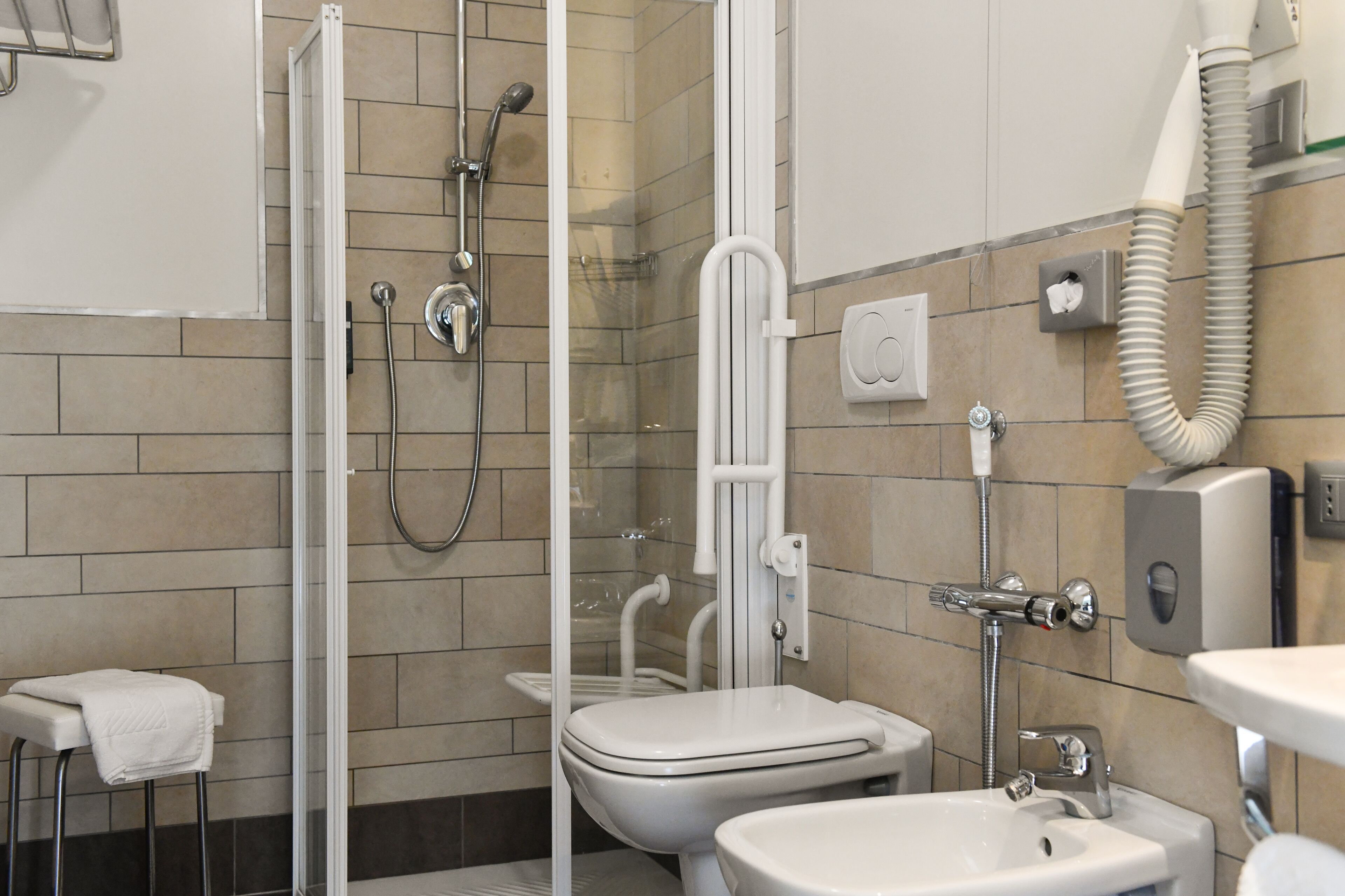 shower, hair dryer, bidet, towels