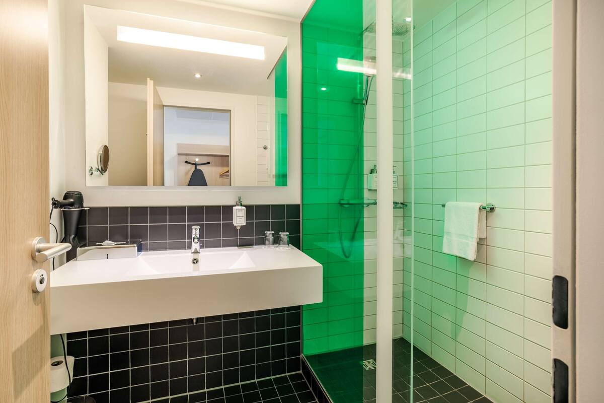superior room (high floor) | bathroom | shower, eco-friendly toiletries, hair dryer, towels