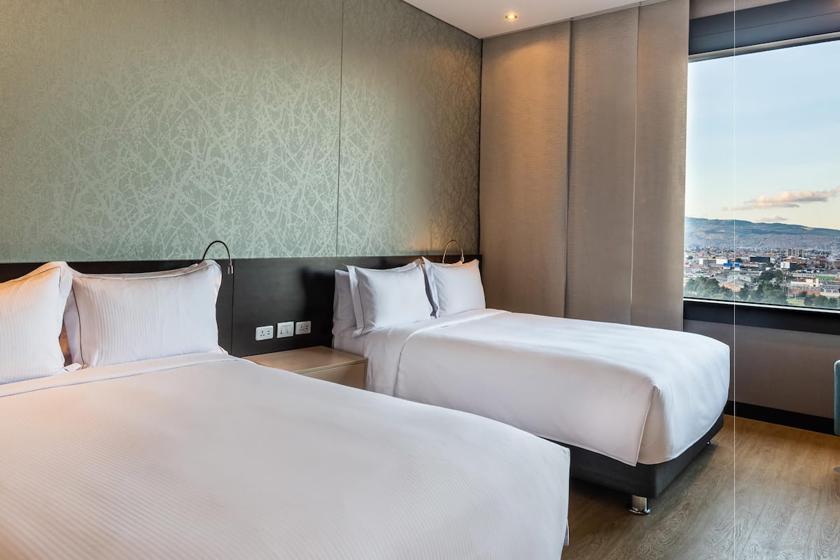 Room, 2 Double Beds | In-room safe, desk, laptop workspace, blackout drapes