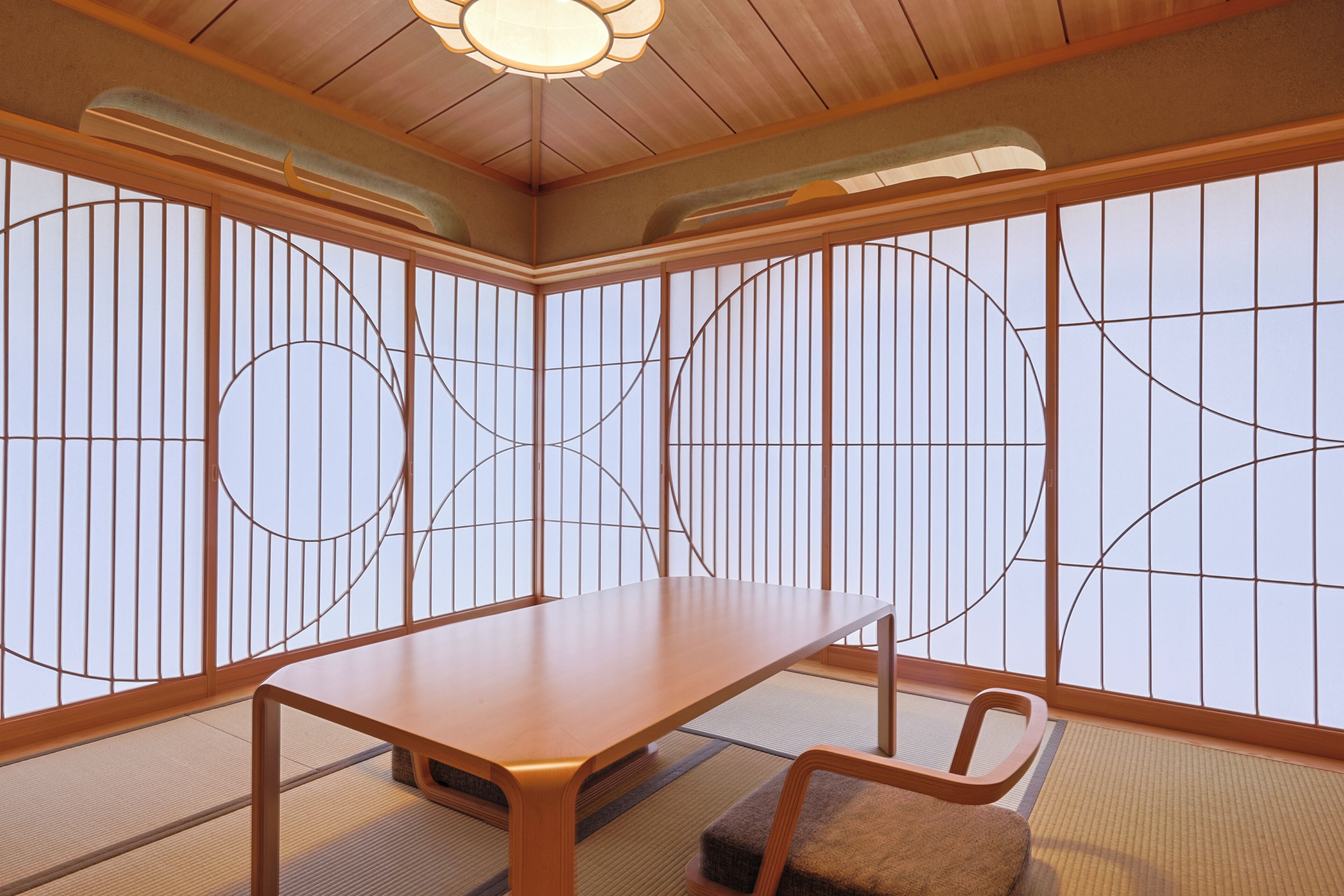 A traditional Japanese room with tatami flooring, a low table, and a chair.