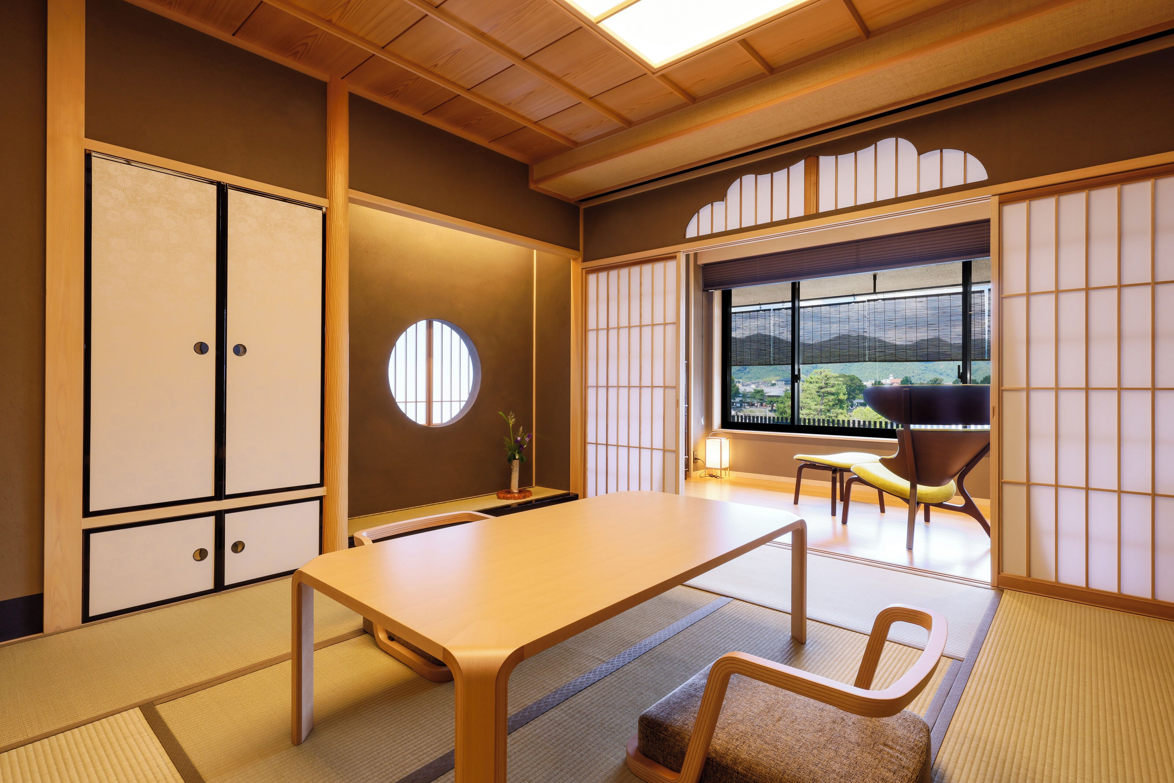 A traditional Japanese room with tatami flooring, a low table, and sliding doors.