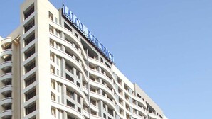 A multi-story hotel with a curved facade and balconies. - Lalco Residency (Mumbai)