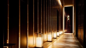A corridor with illuminated vertical light fixtures and a patterned floor. - The St. Regis Osaka (Osaka)