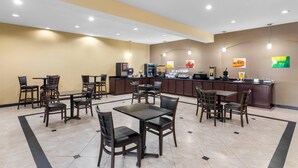 A hotel lobby with multiple seating areas, a reception desk, and a kitchen in the background. - Quality Inn & Suites - Marlin (Marlin)