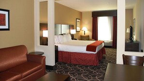 A hotel room with a bed, a desk, a chair, a sofa, and a TV. - Holiday Inn Express & Suites Houston South near Pearland by IHG (Houston)