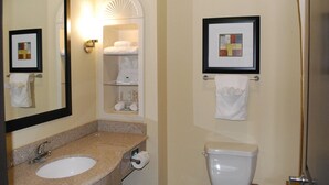A bathroom with a sink, toilet, towel rack, and a framed picture on the wall. - Holiday Inn Express & Suites Houston South near Pearland by IHG (Houston)
