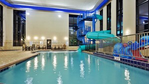 An indoor swimming pool with a blue water slide and a blue spiral staircase. - Holiday Inn Express Hotel & Suites Great Falls by IHG (Great Falls)