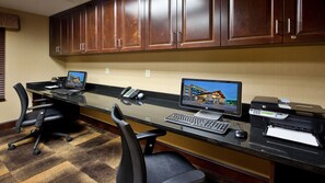 A hotel reception desk with two computer monitors, a printer, and a telephone. - Holiday Inn Express Hotel & Suites Great Falls by IHG (Great Falls)