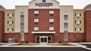 A brick building with a sign reading "CANDLEWOOD SUITES" and a number "1095" on the entrance.