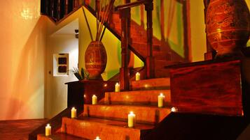 A staircase with multiple steps, each illuminated by a candle.