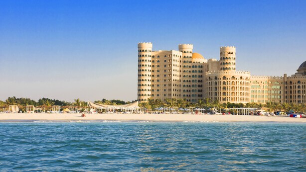 A beachfront hotel with multiple towers, a beach, and a pool area. - Al Hamra Village Hotel (Ras Al Khaimah)