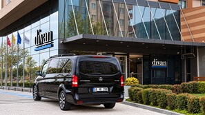 A black Vito van parked in front of a building with a glass facade and the name 'divan' displayed. - Divan Corlu (Corlu)