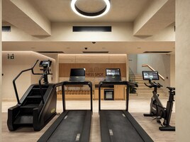 A fitness center with treadmills, an elliptical, and a stationary bike.