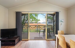 Cabana superior, 2 quartos, vista para o lago | Área de estar | TV de tela plana