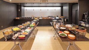 A buffet setup with various food items and beverages. - Candeo Hotels Uenokoen (Tokyo)