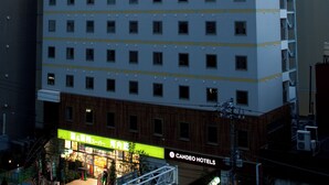A multi-story hotel building with a prominent sign reading "CANDEO HOTELS" and a star logo. The building has a modern architectural design with a flat facade and evenly spaced windows. - Candeo Hotels Uenokoen (Tokyo)