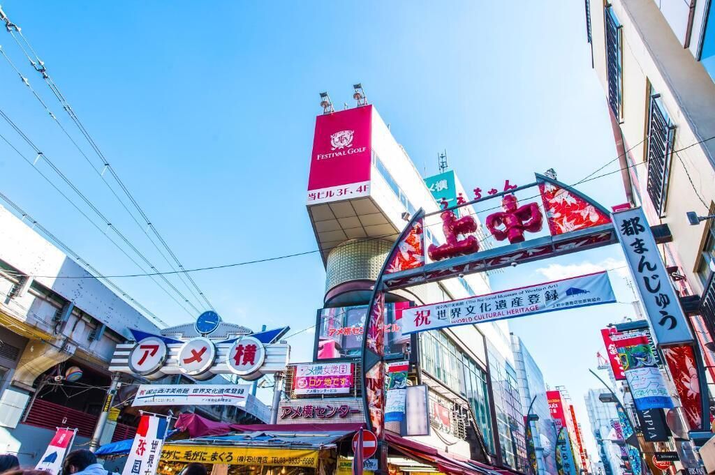 A busy urban street with various signs and advertisements, including a prominent red banner for Festival Golf.
