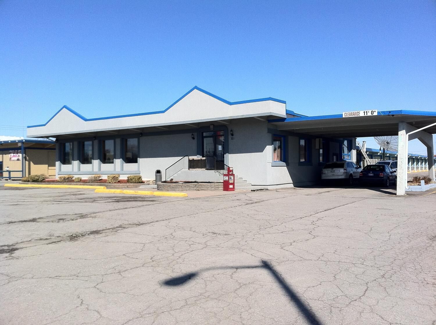 A building with a blue roof and a covered entrance area.