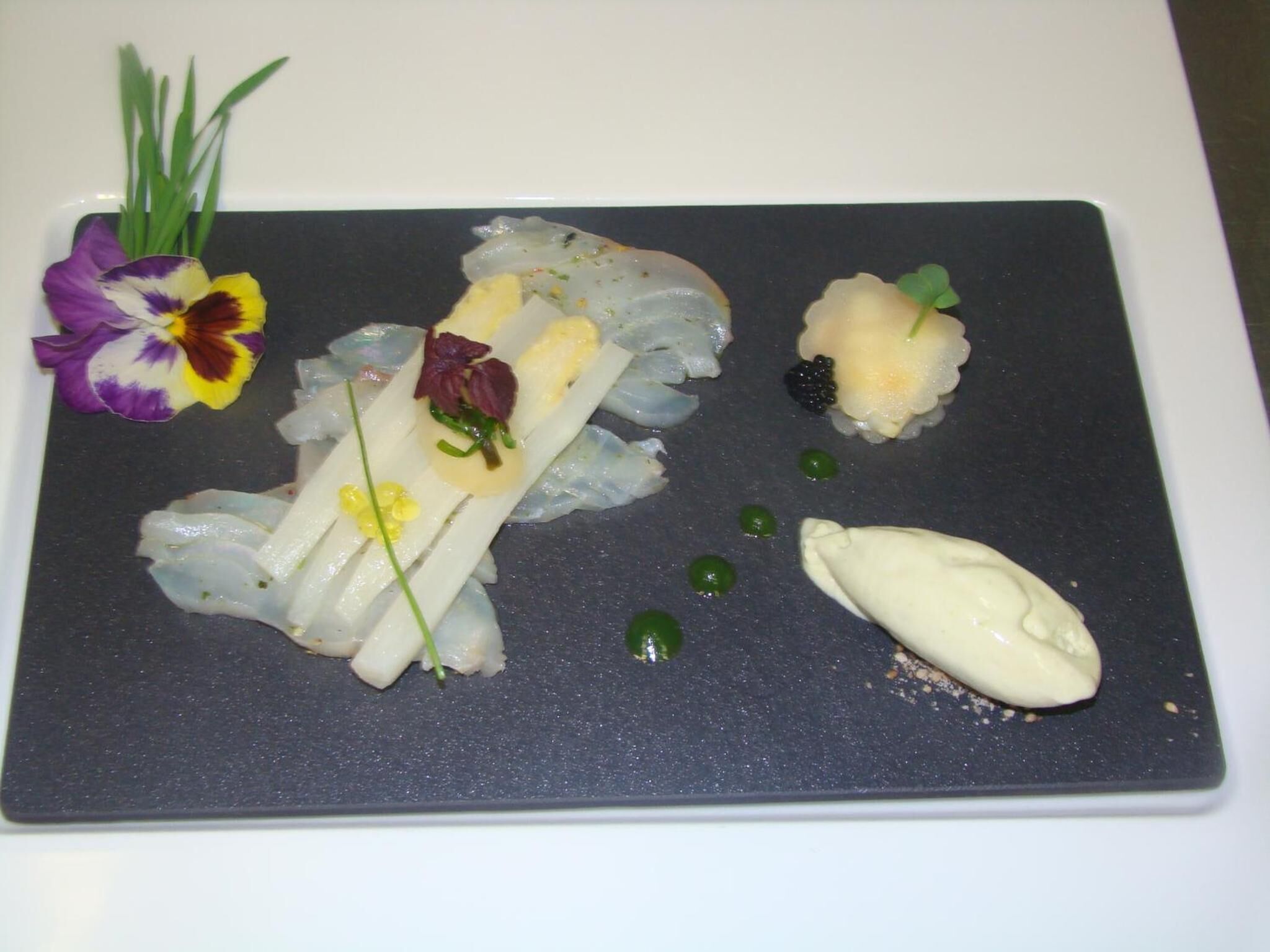 A plate of sushi with various toppings and garnishes.