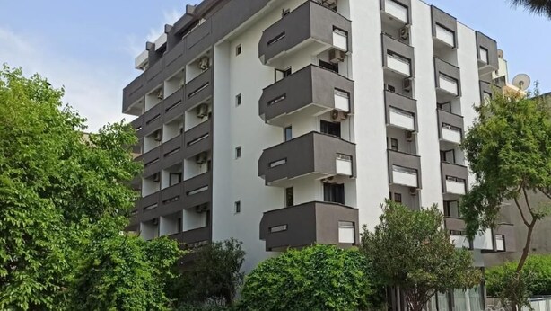 A multi-story hotel building with balconies, a sign reading "HOTEL DIAS", and surrounded by greenery. - Dias (Kusadasi)