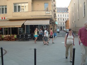 A street scene with a restaurant named "Paul's Hungarian Bistro" and a sign indicating a no parking zone.