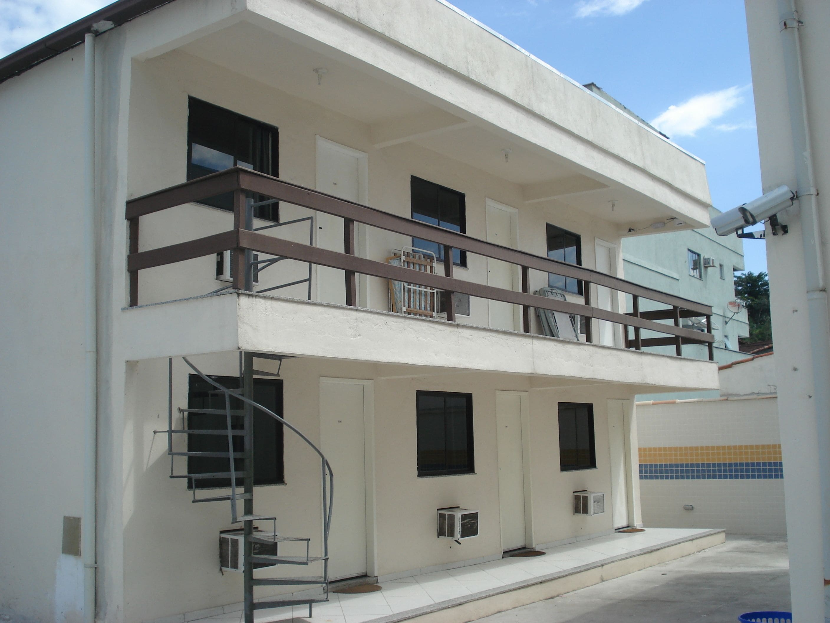A two-story building with a balcony on the upper floor.