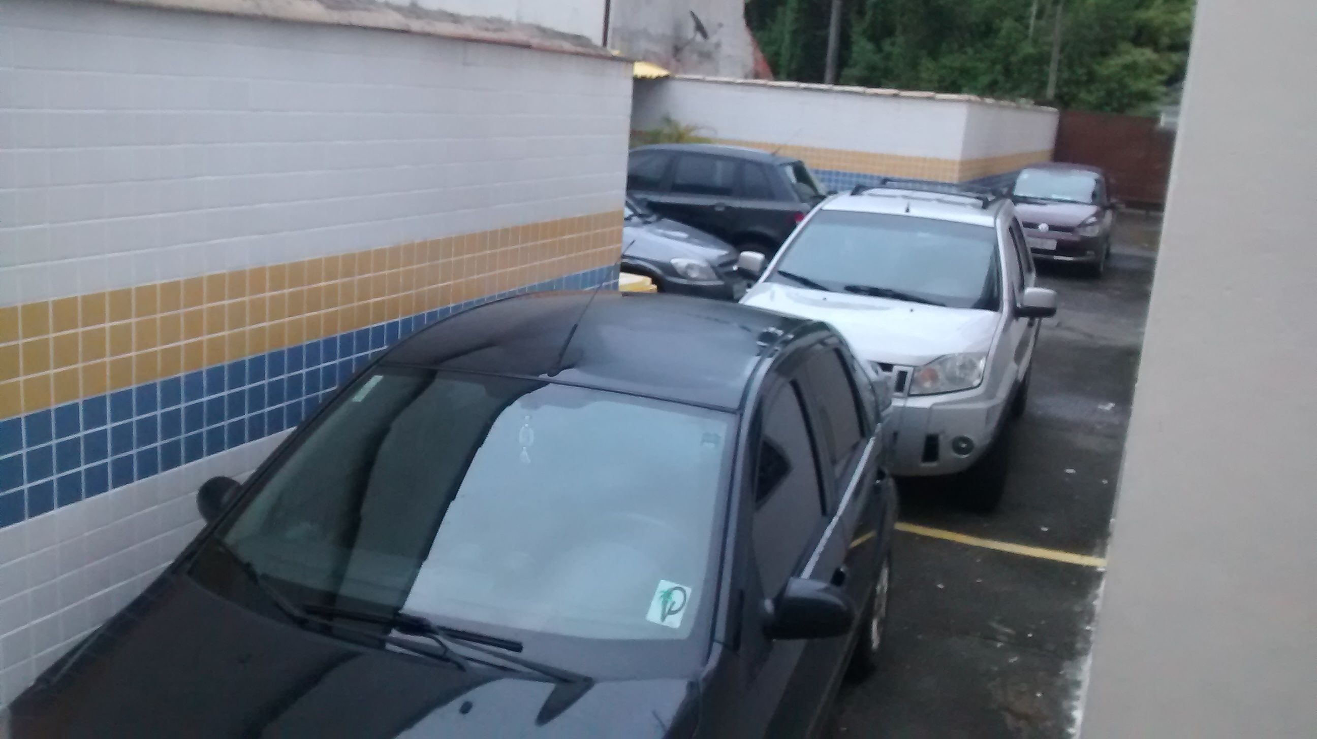 A parking lot with several cars parked.