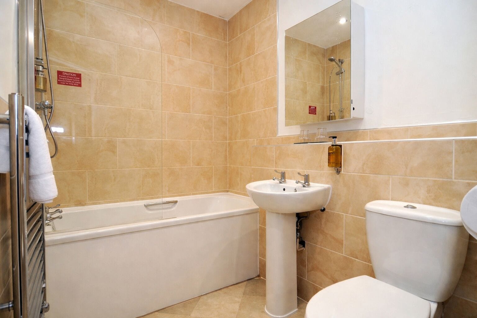 A bathroom with a bathtub, sink, and toilet.